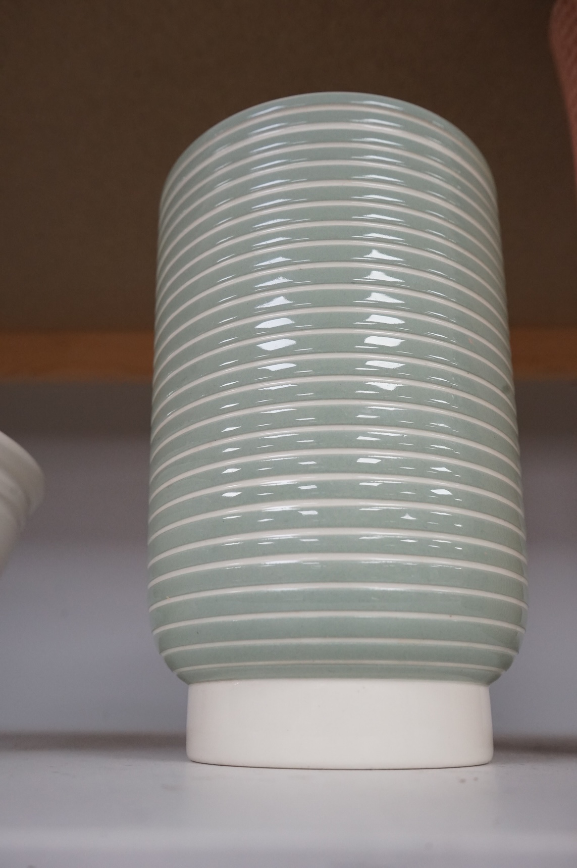 Keith Murray for Wedgwood, a green and cream vase, 18cm high